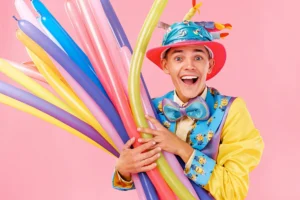 A balloon artist twisting balloon animals surrounded by balloons