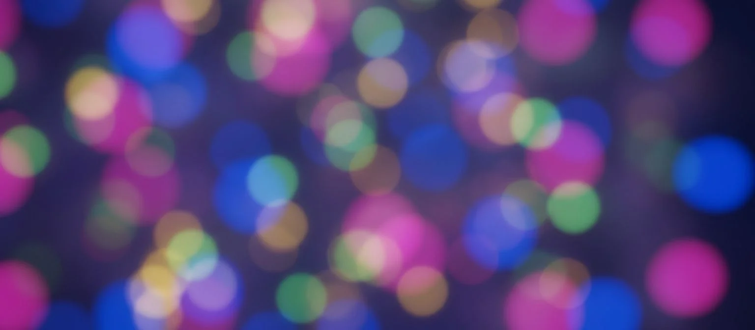 Blurred colourful party lights against a dark background